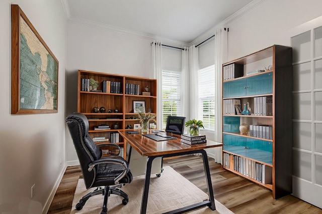 office area with crown molding, baseboards, and wood finished floors