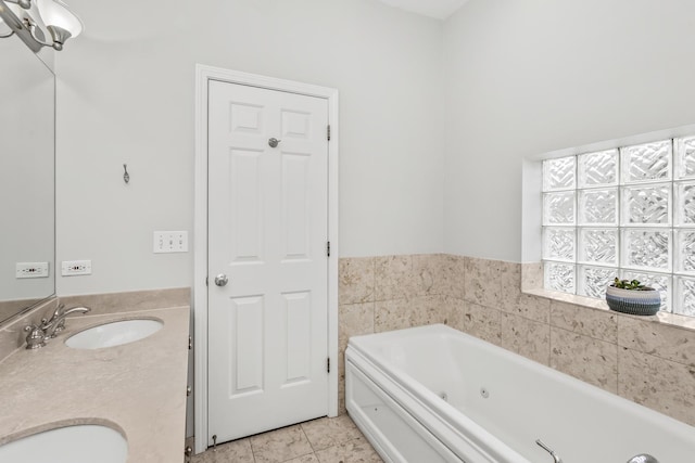 bathroom with tile patterned flooring, vanity, and a washtub