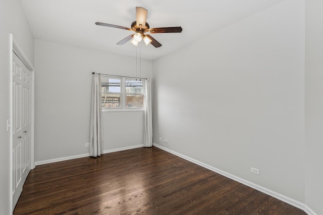 unfurnished bedroom with ceiling fan, dark hardwood / wood-style flooring, and a closet