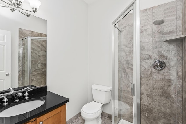 bathroom featuring walk in shower, vanity, and toilet