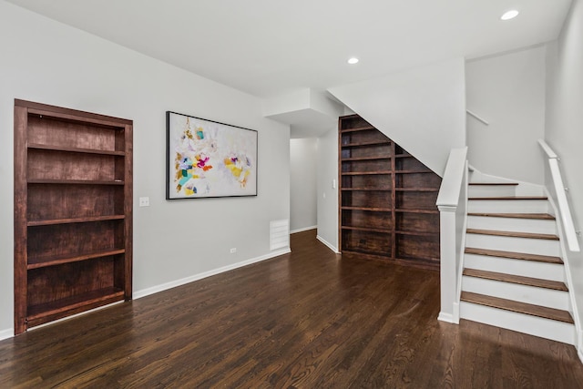 unfurnished living room featuring dark hardwood / wood-style floors