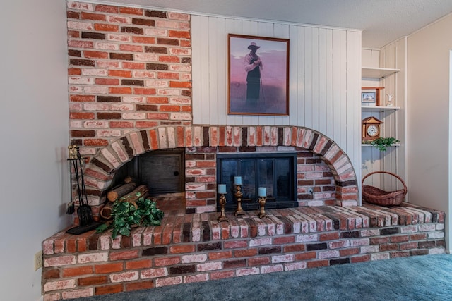 interior details with a brick fireplace and a textured ceiling