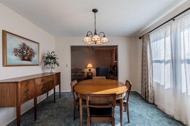 dining area with carpet flooring and an inviting chandelier