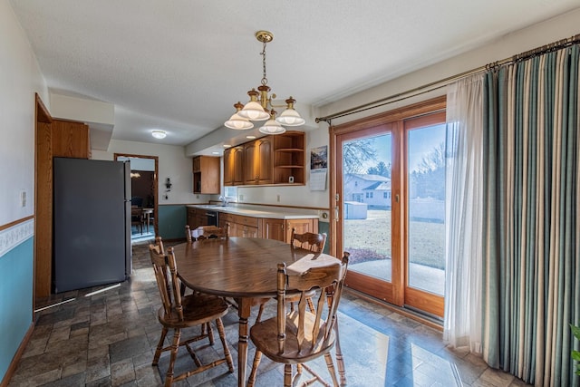 dining room with sink and a textured ceiling