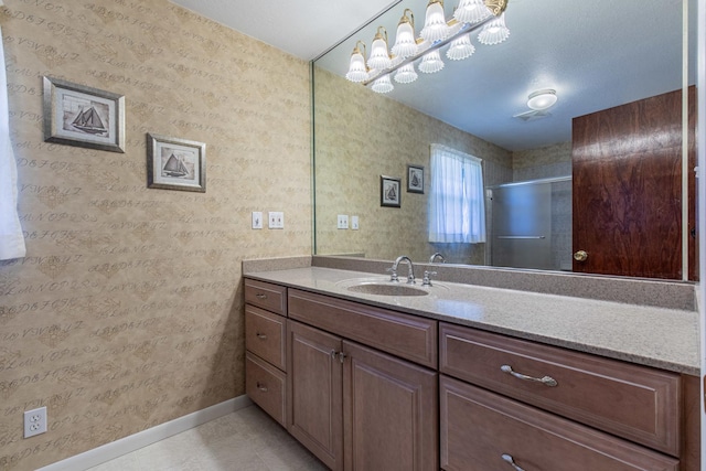 bathroom with vanity, an enclosed shower, and tile patterned floors