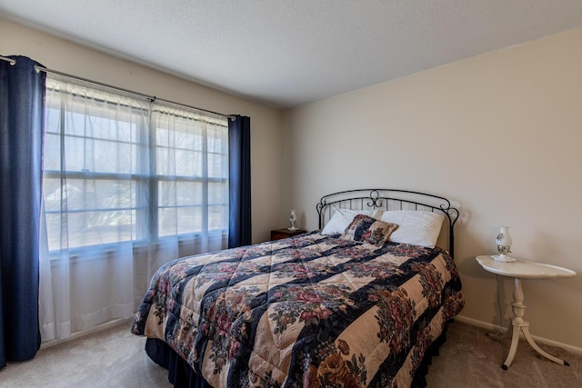 bedroom with carpet and a textured ceiling