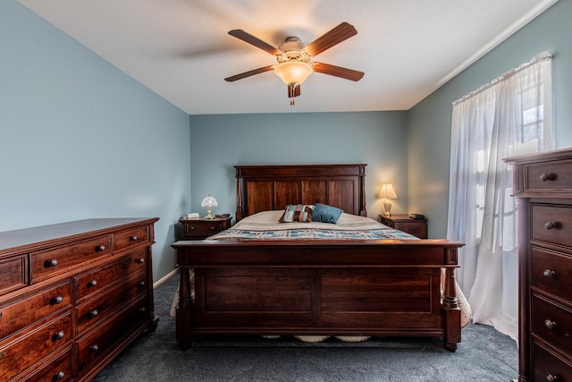 bedroom featuring dark colored carpet and ceiling fan