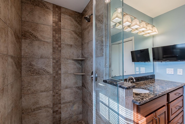 bathroom with vanity and tiled shower