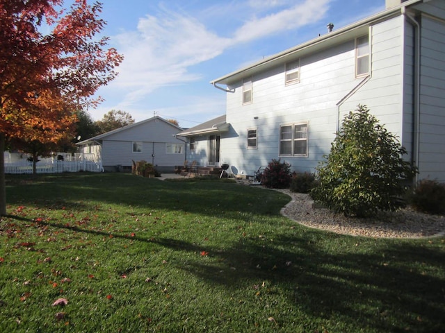 back of property featuring a lawn