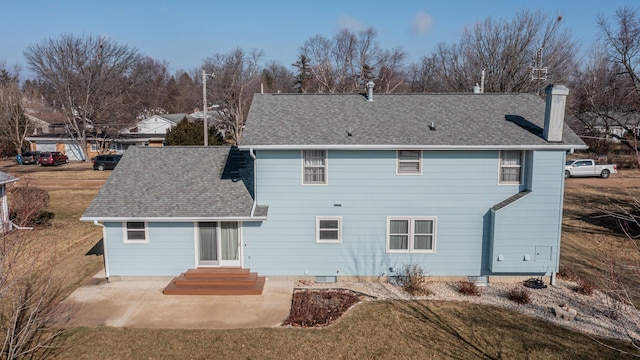 back of property with a yard and a patio