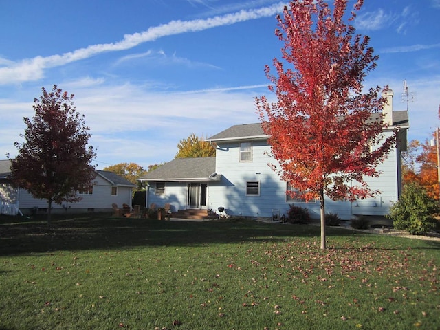 back of property with a yard