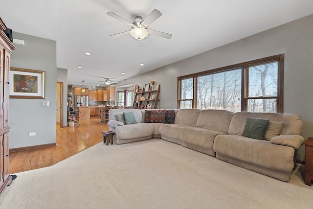 living room featuring ceiling fan and light wood-type flooring