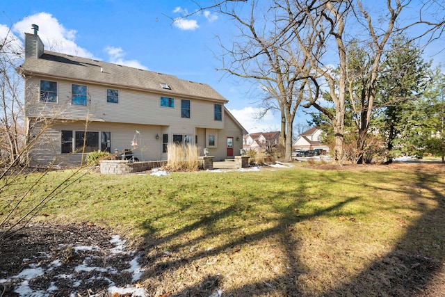 rear view of house with a yard and a patio area