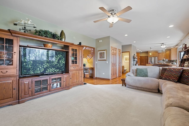 living room with light carpet and ceiling fan