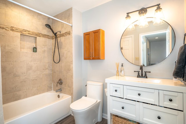 full bathroom with tiled shower / bath combo, vanity, and toilet