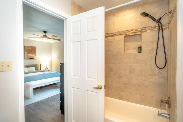 bathroom with ceiling fan, wood-type flooring, and tiled shower / bath combo