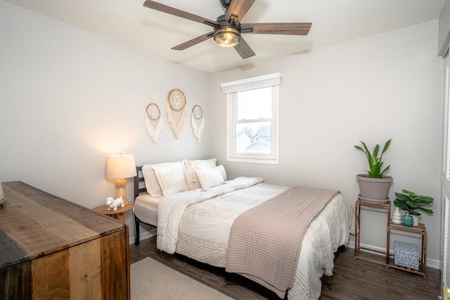 bedroom with ceiling fan and dark hardwood / wood-style flooring