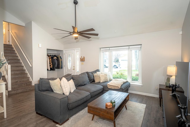 living room featuring ceiling fan, dark hardwood / wood-style flooring, and vaulted ceiling