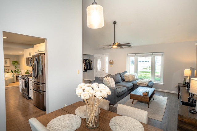 living room featuring a high ceiling, dark hardwood / wood-style floors, and ceiling fan