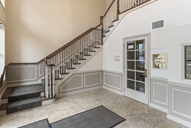 foyer featuring a towering ceiling