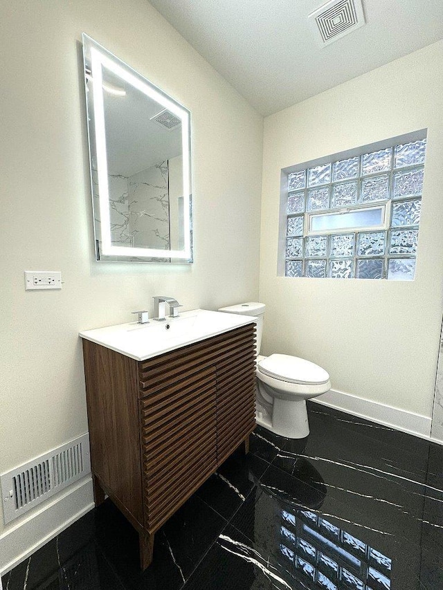 bathroom featuring vanity and toilet