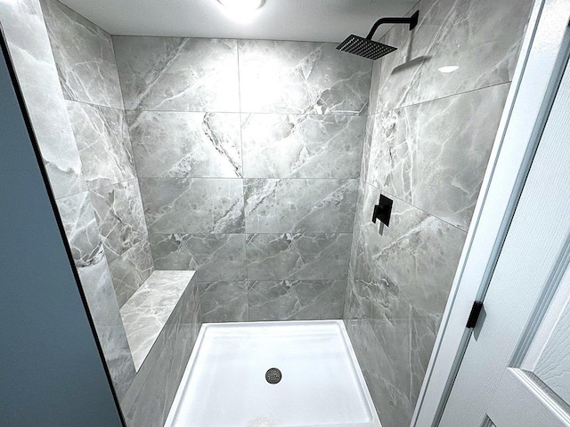 bathroom with tiled shower