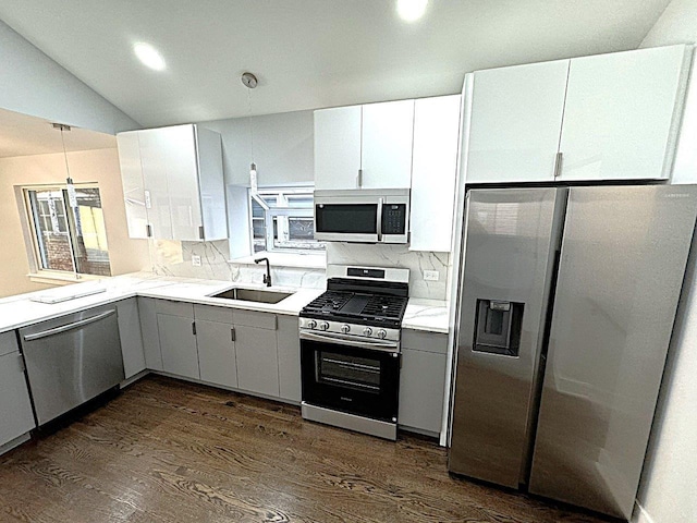 kitchen featuring dark hardwood / wood-style floors, white cabinetry, sink, backsplash, and stainless steel appliances