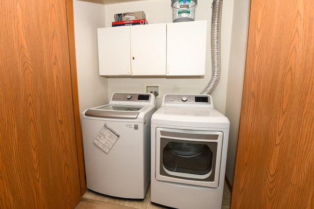 washroom featuring independent washer and dryer and cabinets