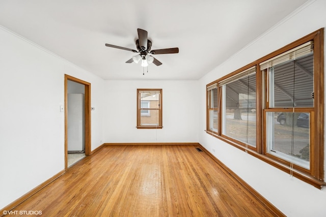 unfurnished room featuring ceiling fan, ornamental molding, and light wood-type flooring