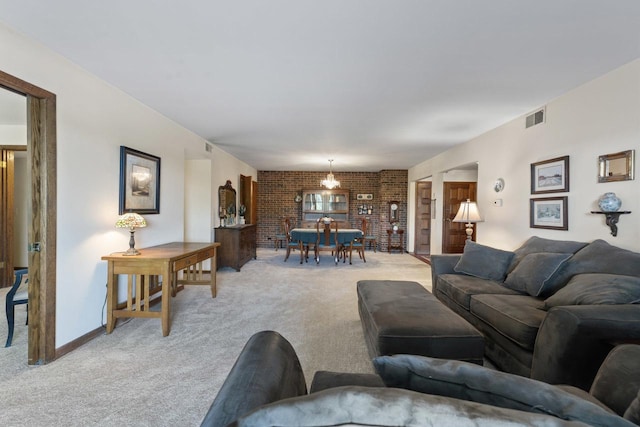 living room featuring brick wall and light colored carpet