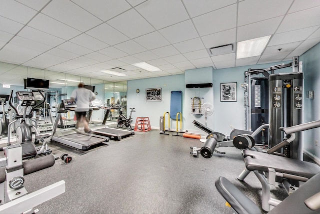 exercise room featuring a paneled ceiling