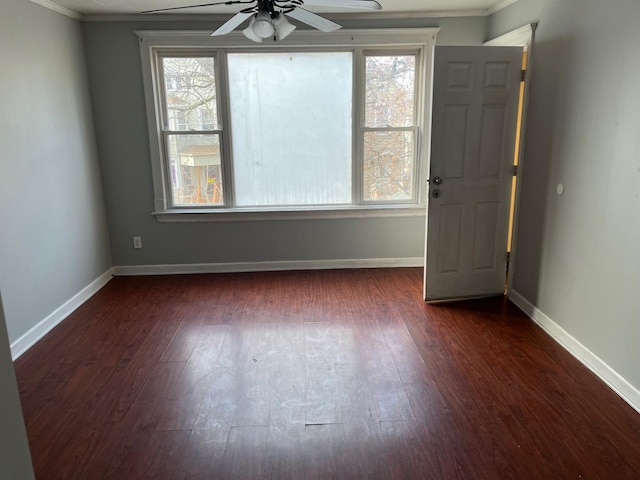 spare room featuring crown molding, ceiling fan, and dark hardwood / wood-style flooring