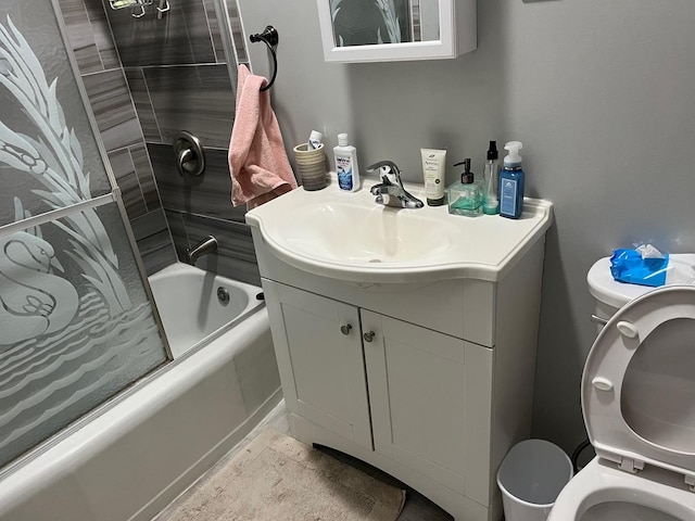 full bathroom with washtub / shower combination, vanity, and toilet