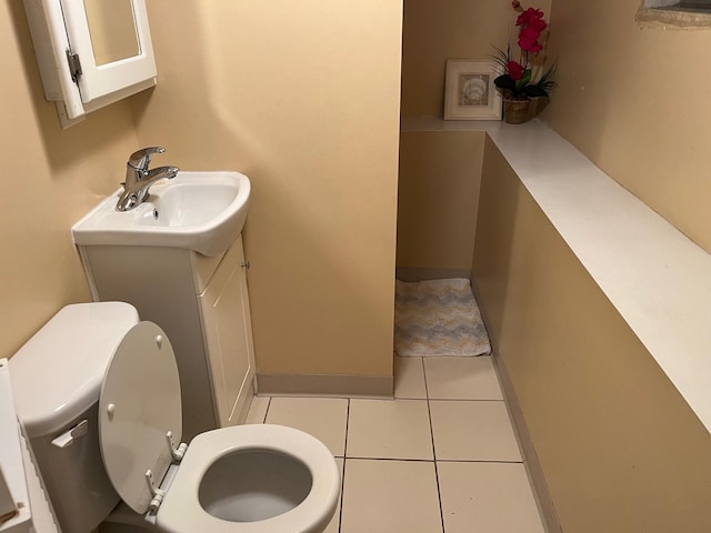 bathroom with tile patterned flooring, vanity, and toilet