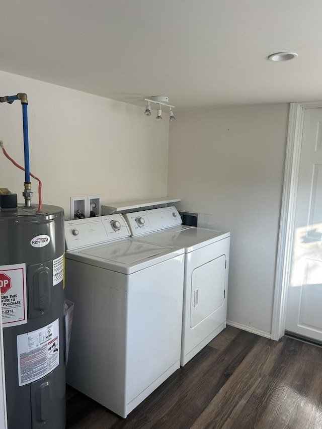 laundry room with dark hardwood / wood-style flooring, water heater, and washing machine and clothes dryer