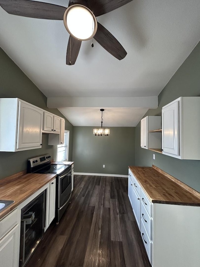 kitchen featuring white cabinetry, wooden counters, hanging light fixtures, and electric range