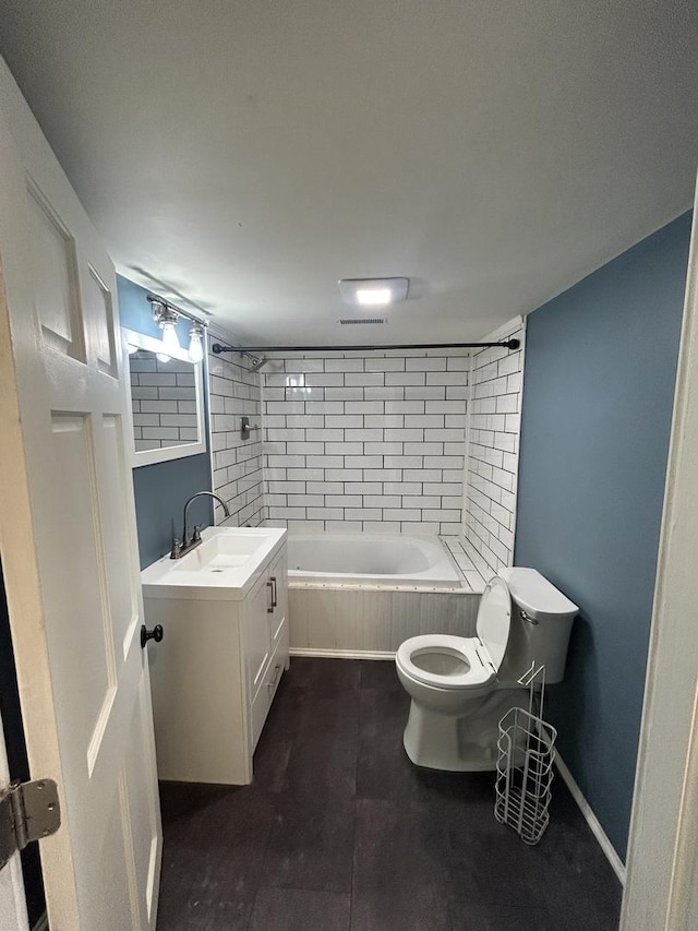 full bathroom featuring vanity, toilet, and tiled shower / bath combo