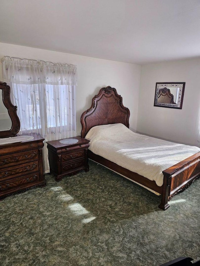 bedroom with dark colored carpet