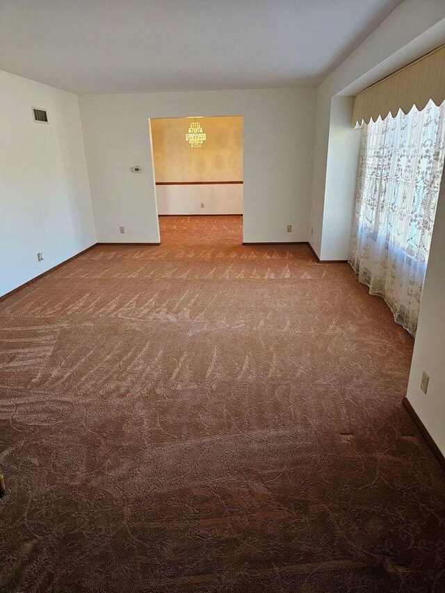 living room with carpet flooring and a notable chandelier