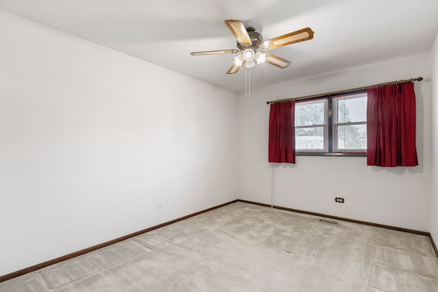 unfurnished room with light colored carpet and ceiling fan