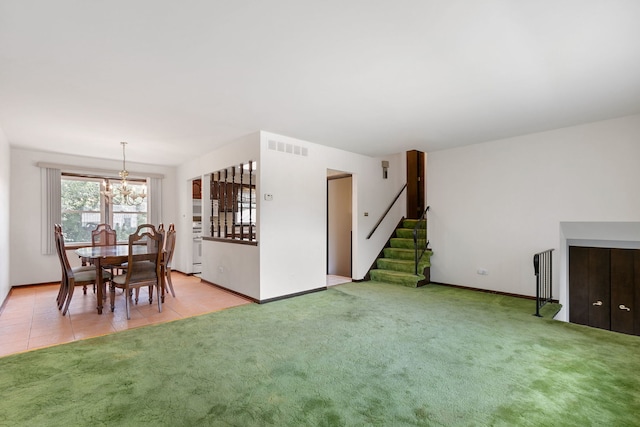 carpeted living room featuring a notable chandelier