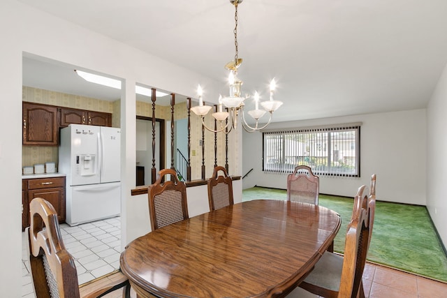 dining area with light tile patterned flooring and a notable chandelier