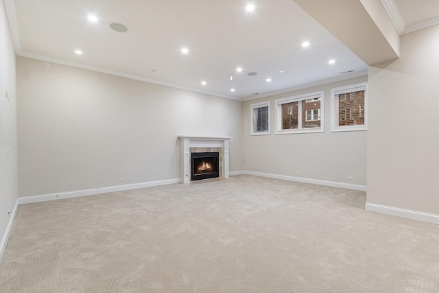 unfurnished living room featuring light colored carpet, ornamental molding, and a tile fireplace