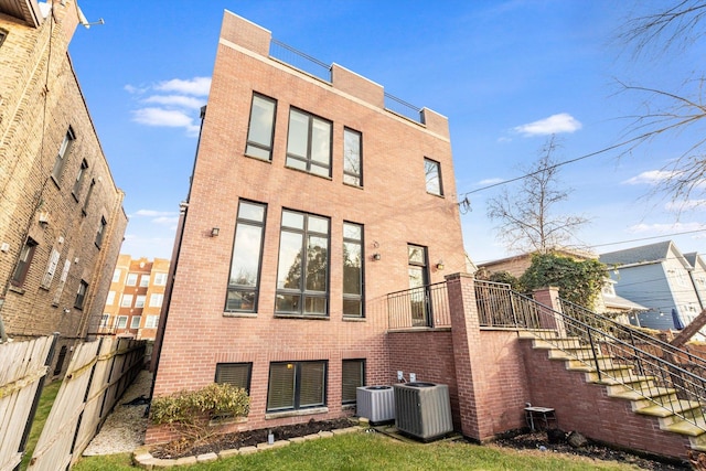 rear view of house featuring central air condition unit