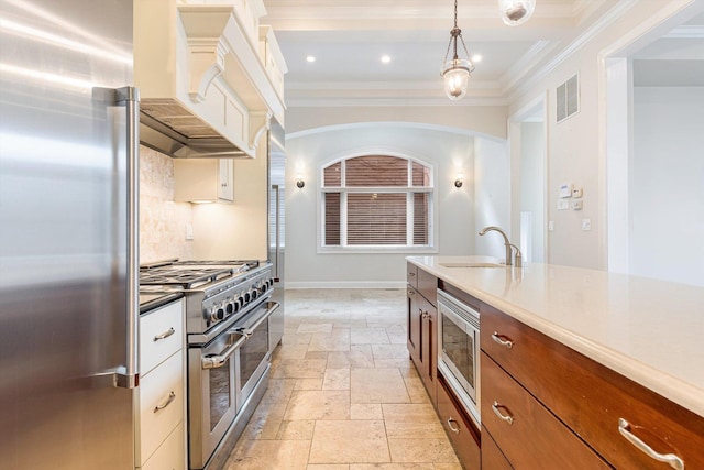 kitchen featuring high quality appliances, custom exhaust hood, ornamental molding, and decorative light fixtures