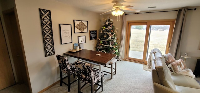 office area featuring light carpet and ceiling fan