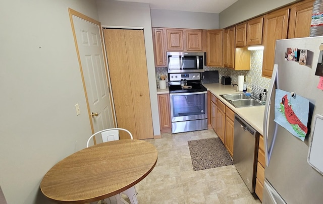 kitchen featuring sink, decorative backsplash, and appliances with stainless steel finishes