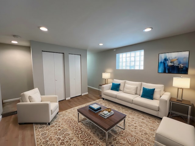 living room with recessed lighting, baseboards, and wood finished floors