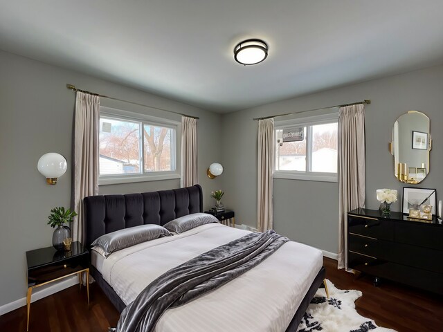 bedroom featuring dark wood-style floors and baseboards