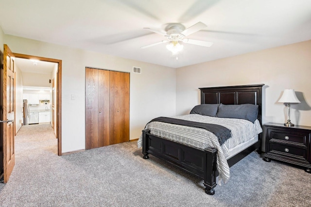 bedroom with a closet, ceiling fan, and carpet flooring